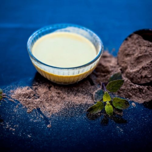 Ayurvedic herb brahmi or Waterhyssop with its beneficial paste ina  glass bowl along with its powder on wooden surface.